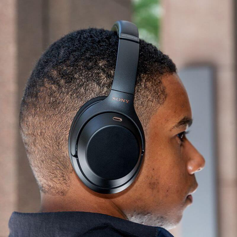 Black Wireless Sony WH-1000XM3 on person's head 