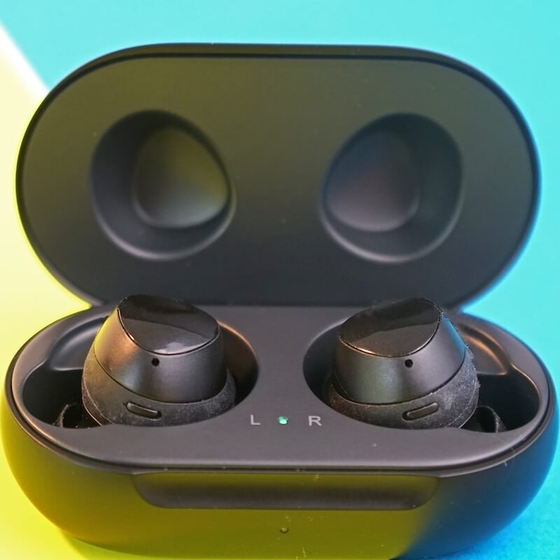 Black Samsung Galaxy Buds on blue and yellow background